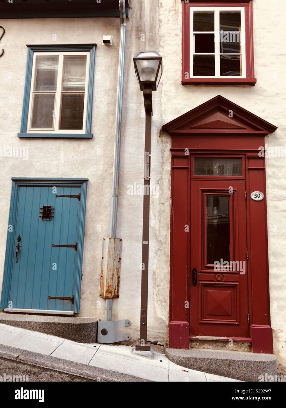 Old Walled city of Quebec in Canada. Streets are narrow and there are hills  but the doors seem to all be straight and quite colourful! - Smartphone Captured Stock Image