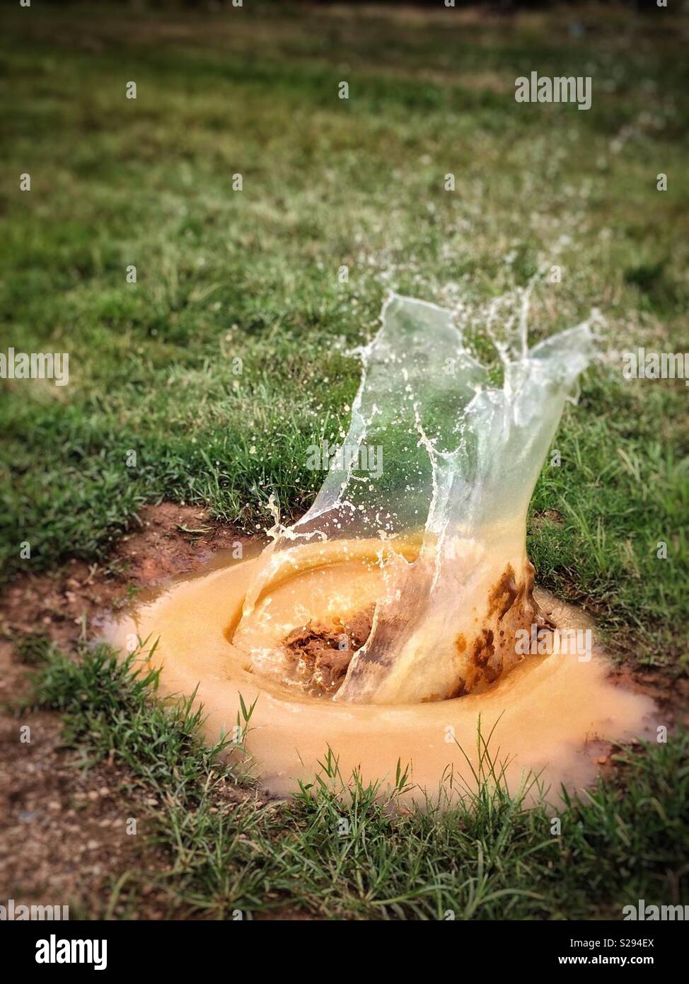 Large splash in deep, muddy puddle Stock Photo Alamy