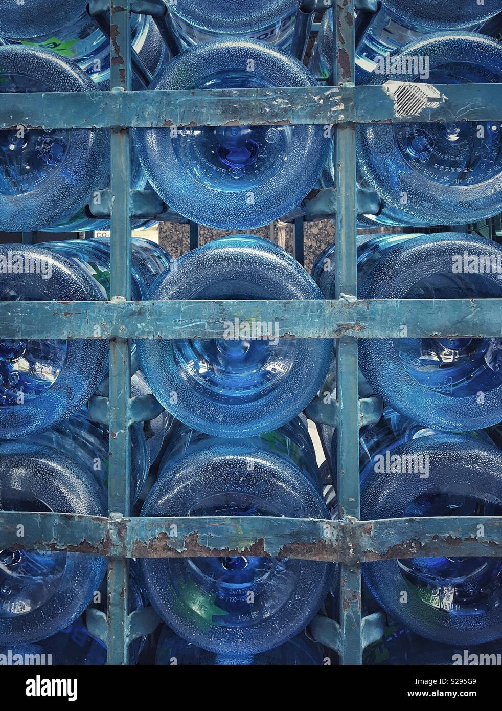 Cage with 5-gallon water jugs Stock Photo