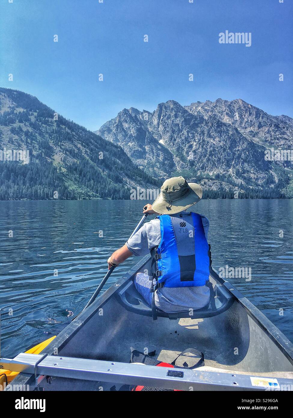 Canoeing with mountains in the background Stock Photo