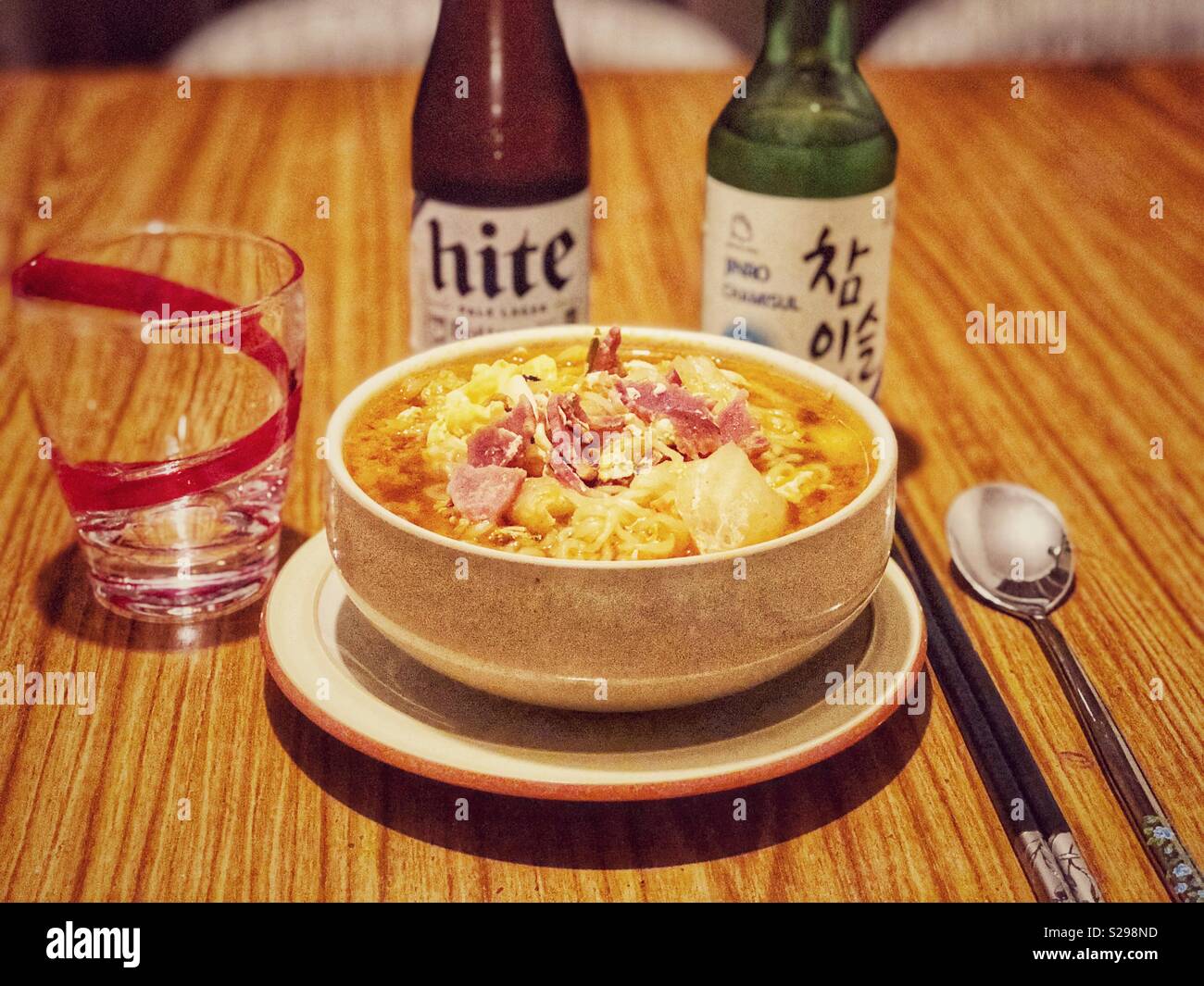 A bowl of ramen noodle soup with bottles of beer and sodju Stock Photo -  Alamy