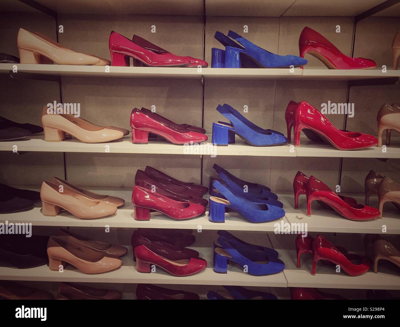 A display of shoes lined up in rows on shelves in a shop. - Smartphone Captured Stock Image