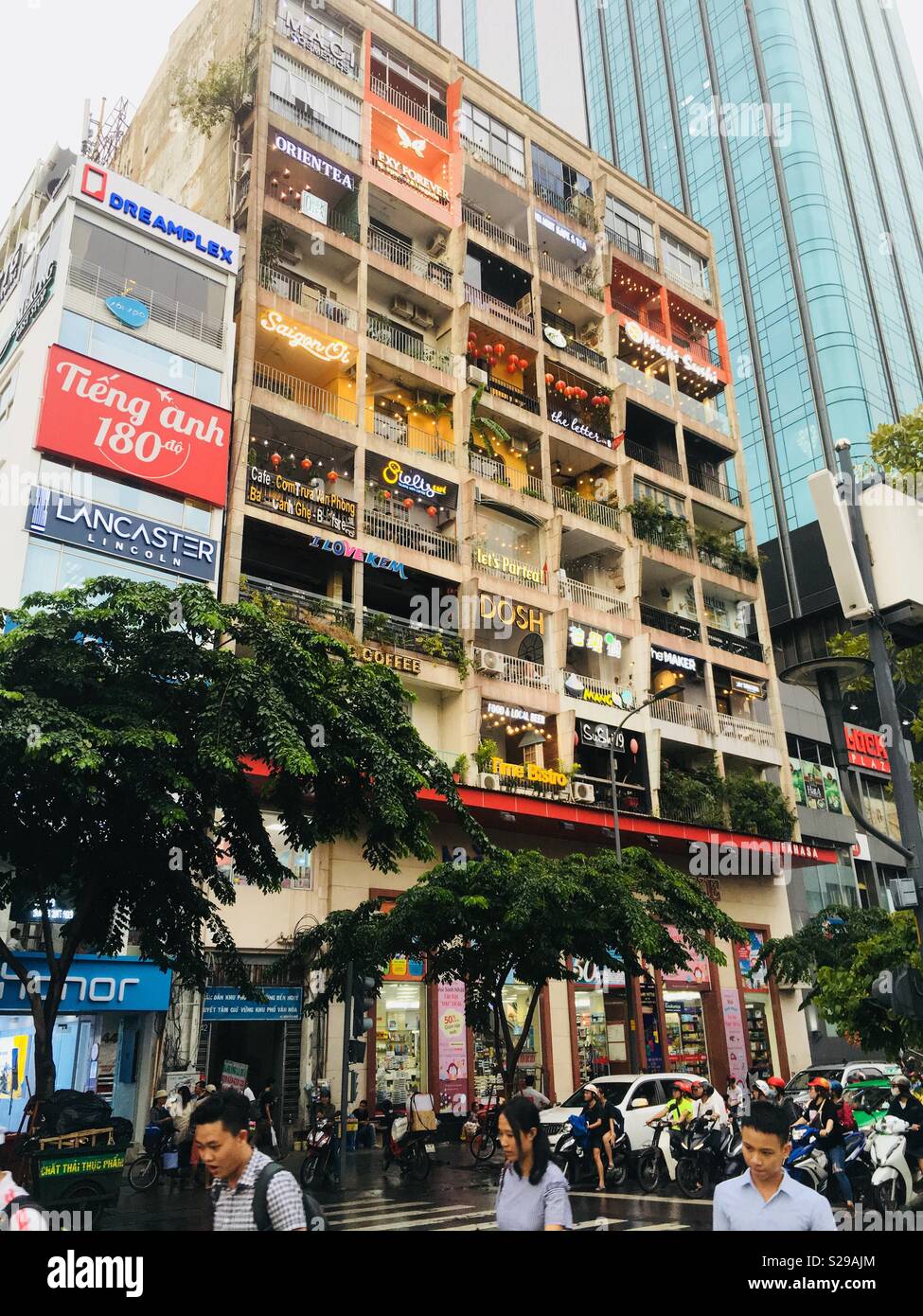 Ho Chi Minh City Vietnam a residential block of flats converted into individual shops and cafes - Smartphone Captured Stock Image