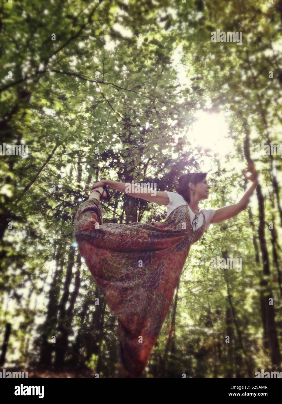 Woman in the forest practicing Yoga Stock Photo - Alamy