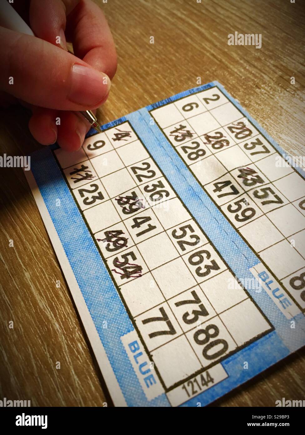 Child playing Bingo .... photo shows a child’s hand marking off a Prize Bingo card. Stock Photo
