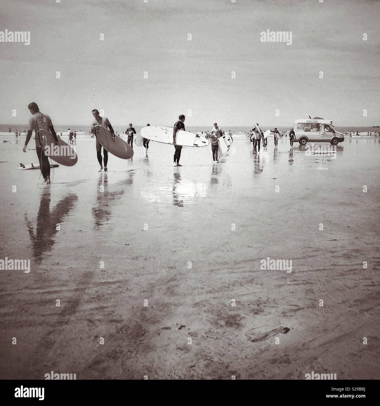 Line of surfers and ice cream van at Polzeath - Smartphone Captured Stock Image