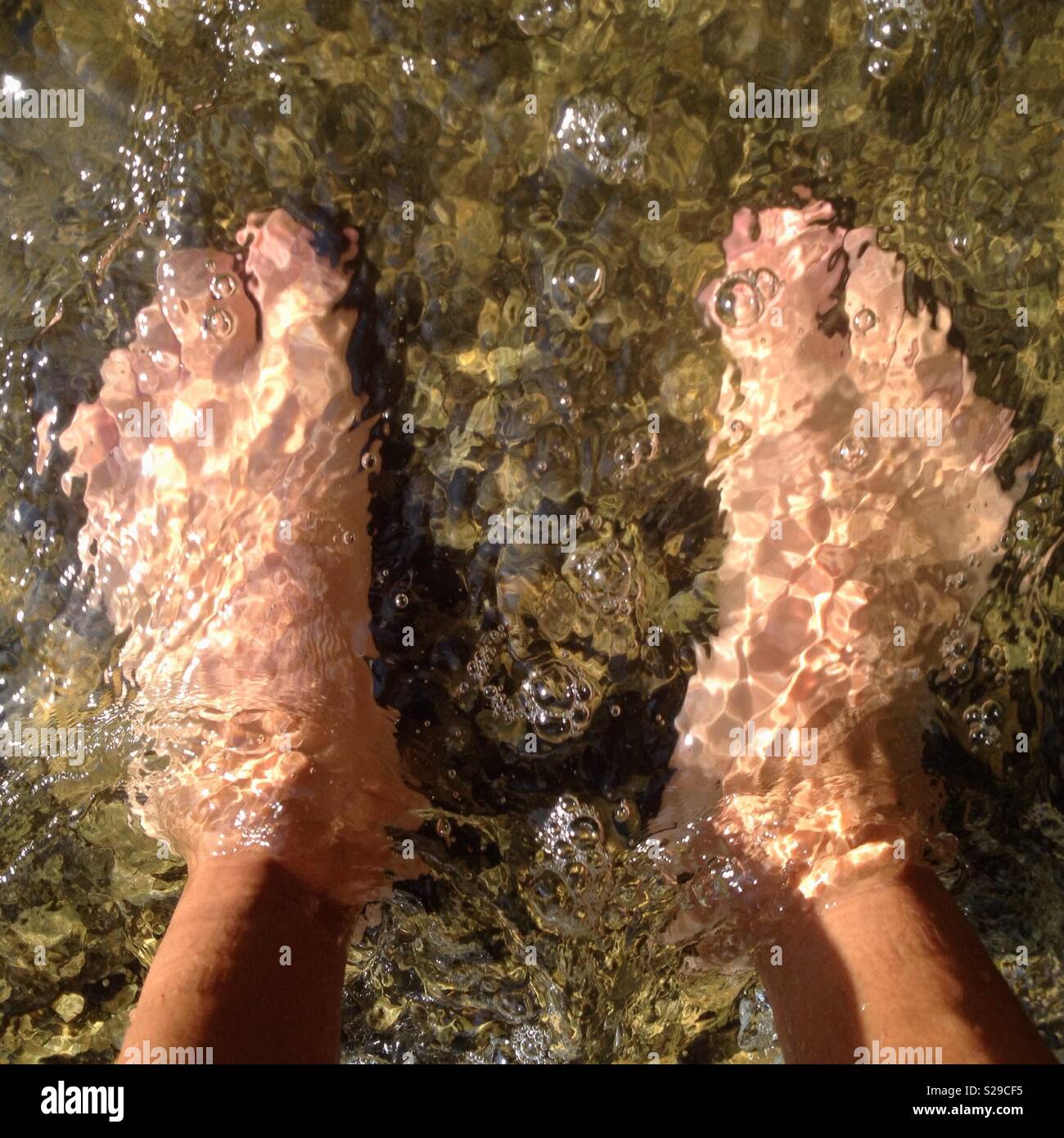 Heat wave, cooling feet in the water - Smartphone Captured Stock Image