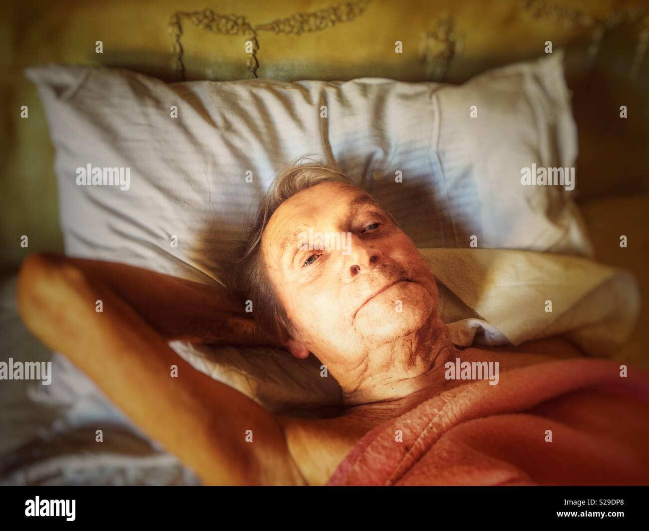 Elderly man in bed - Smartphone Captured Stock Image
