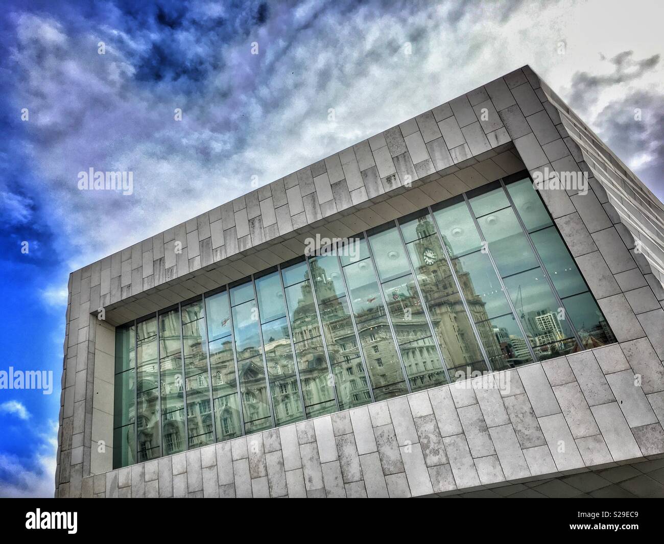 Three Graces on Liverpool riverfront reflected in window on the Museum of Liverpool building - Smartphone Captured Stock Image
