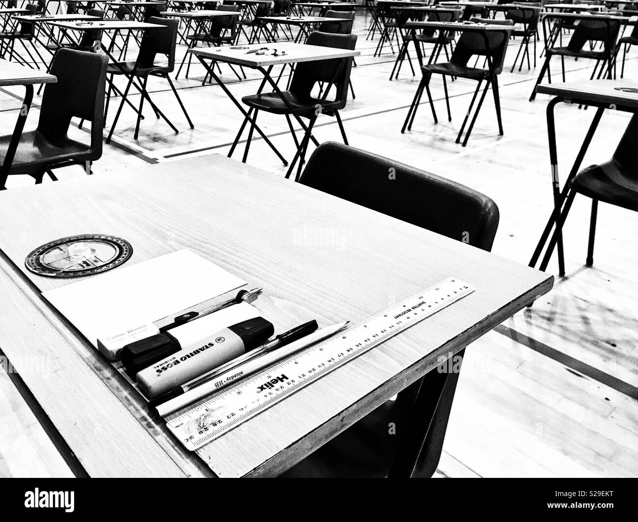 Exam tables waiting for students Stock Photo