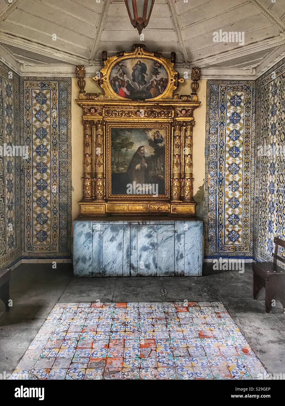 Santa Clara Convent, built for Franciscan Sisters in the 16th Century and still in use today, Funchal, Madeira, Portugal, A side chapel with religious art and hand painted wall tiles - Smartphone Captured Stock Image