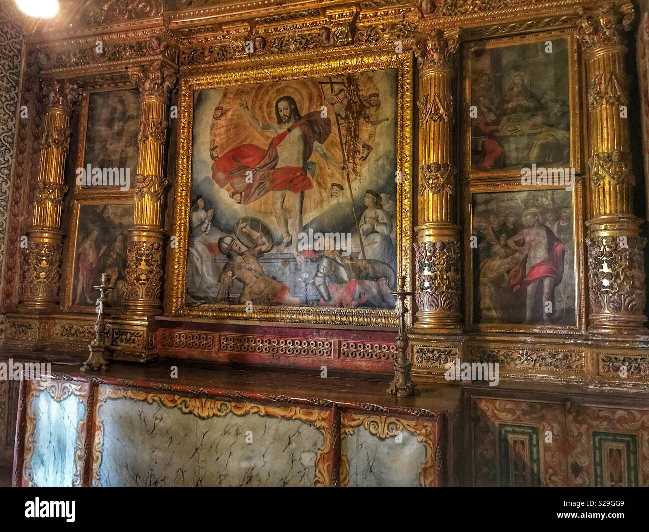 Santa Clara Convent, built for Franciscan Sisters in the 16th Century and still in use today, Funchal, Madeira, Portugal. Religious art  and candlesticks - Smartphone Captured Stock Image