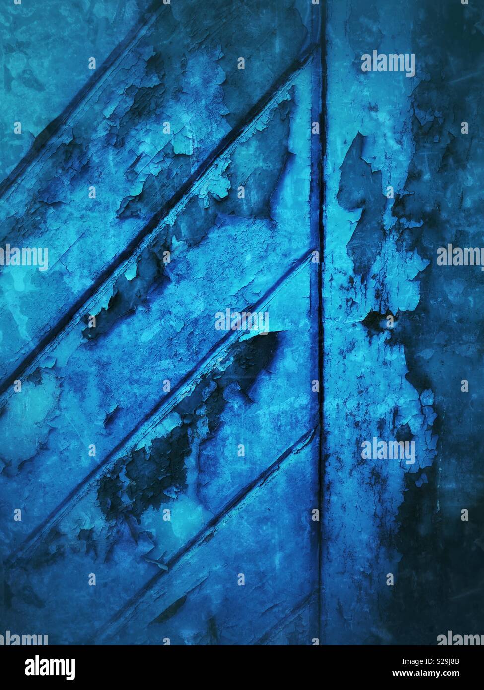 Textured old blue door with flaking paint. - Smartphone Captured Stock Image