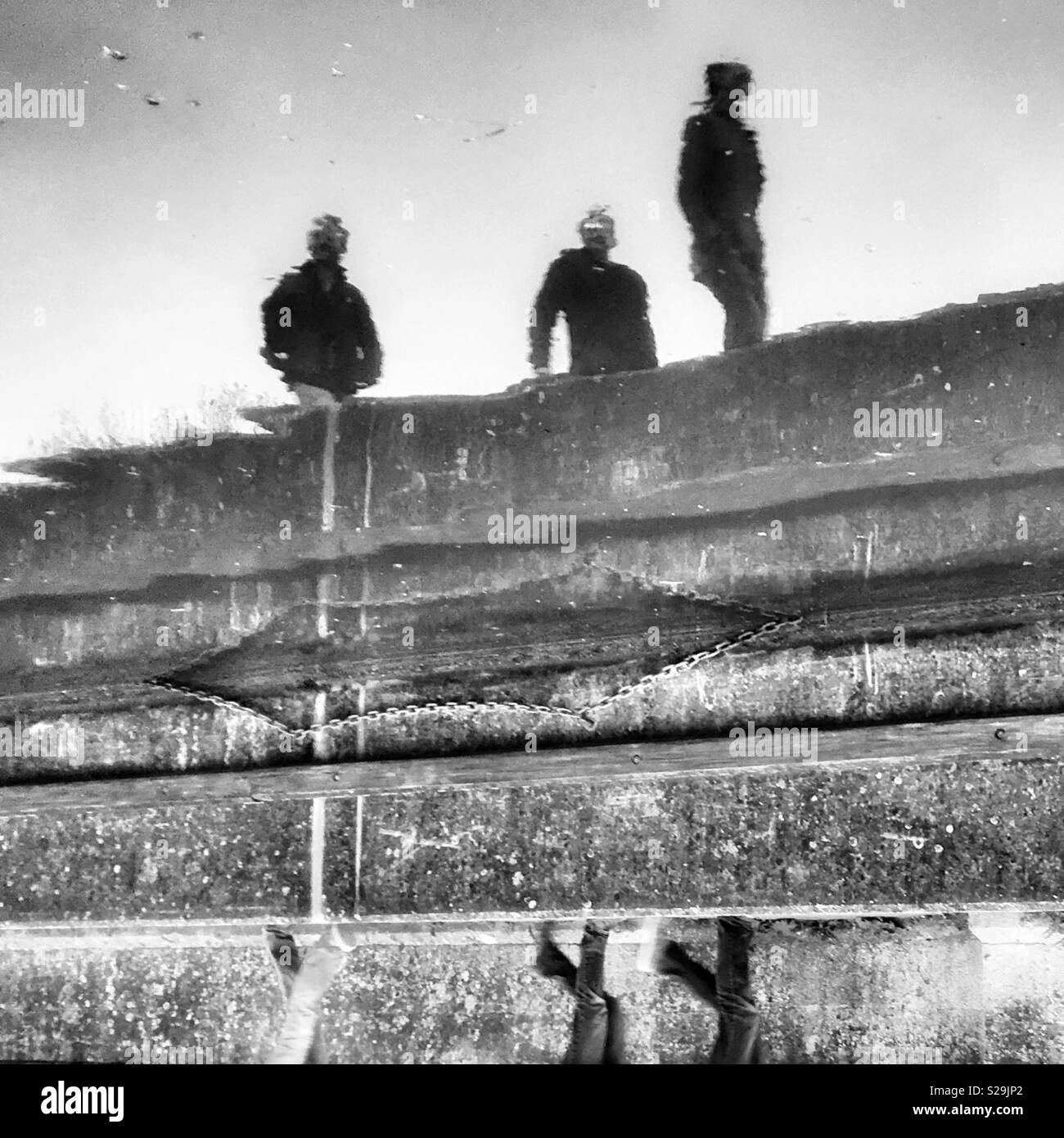 3 figures reflected - Smartphone Captured Stock Image