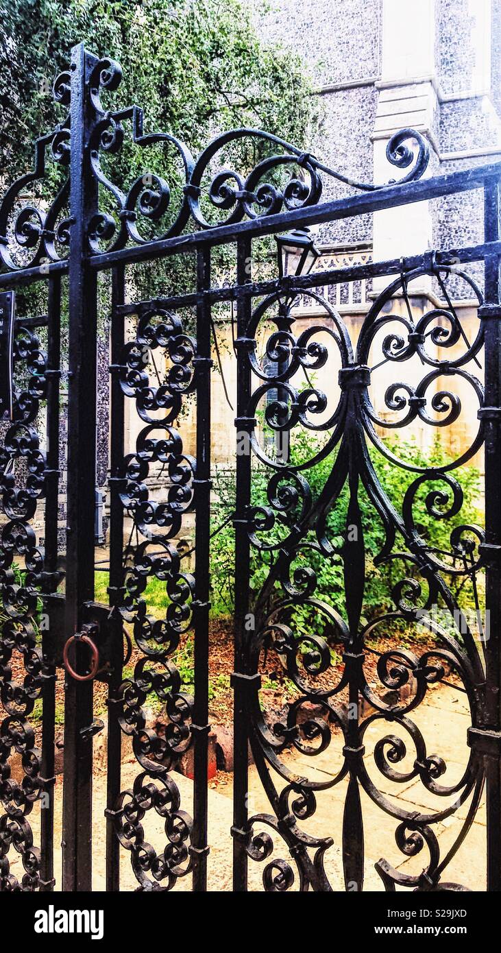 Overwrought. Or just wrought iron. There’s something special about church gardens. Stock Photo