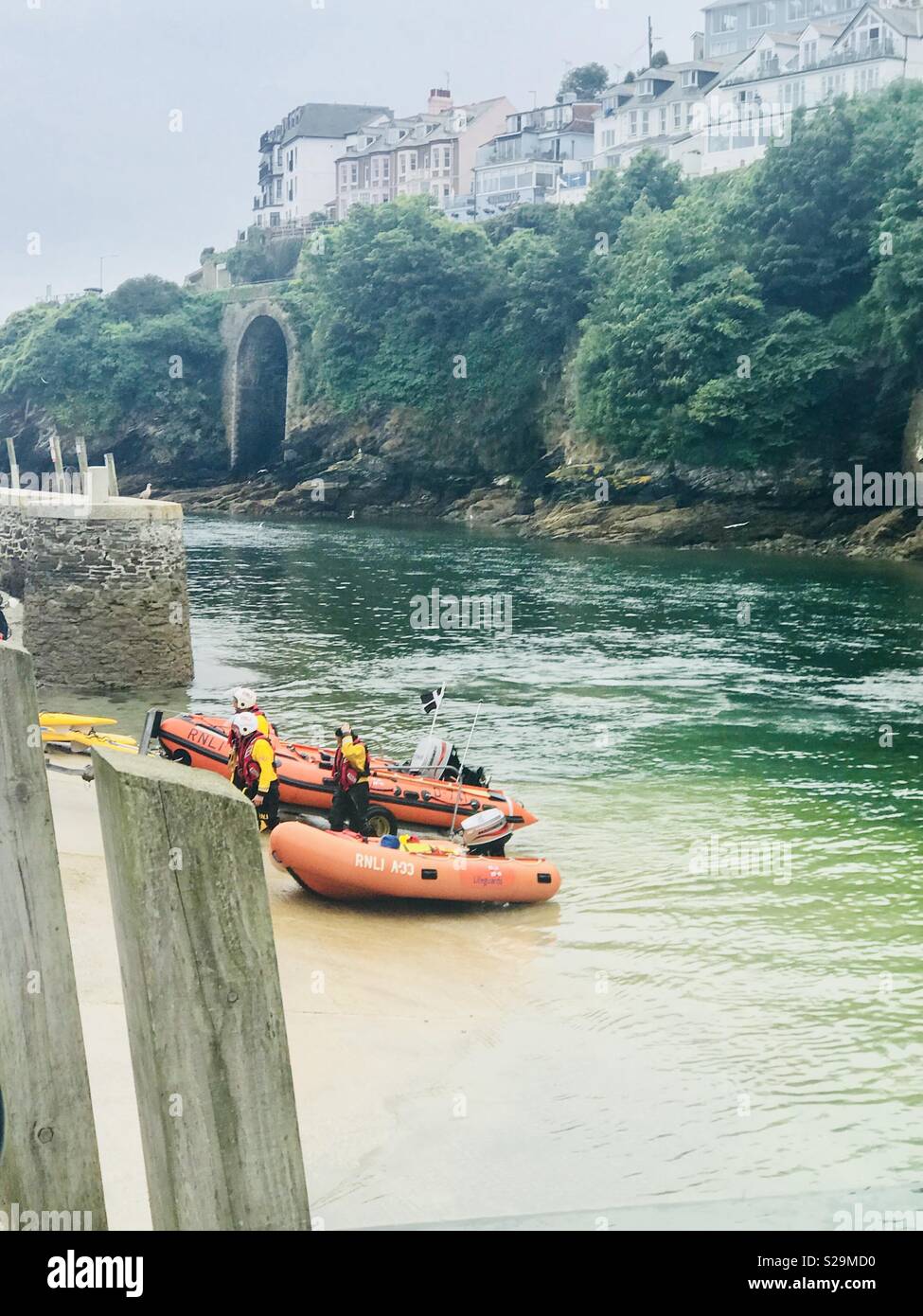 RNLI in Looe Harbour Cornwall with inflatables . Stock Photo