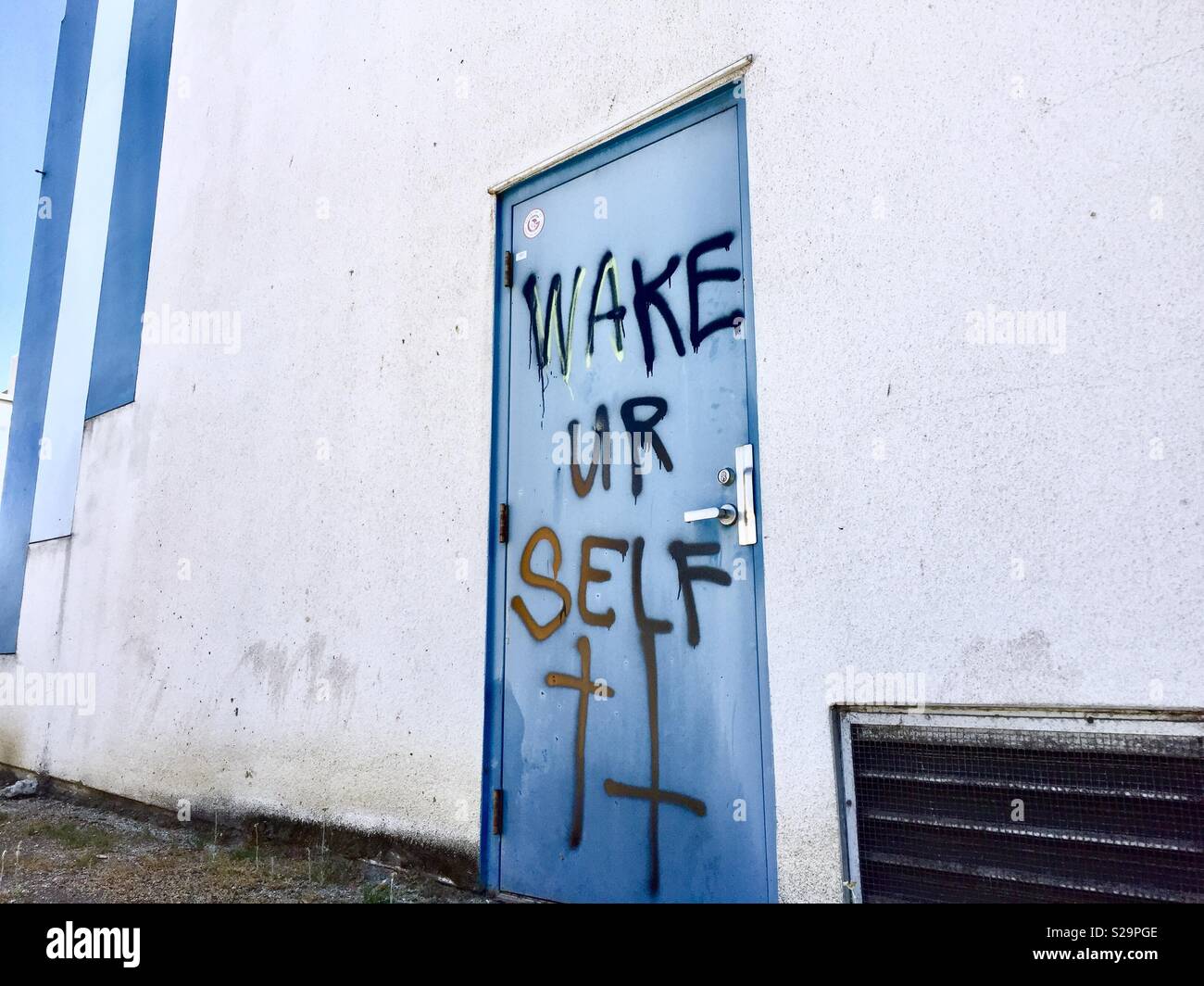Graffiti on blue door in Emeryville, California, USA. Stock Photo
