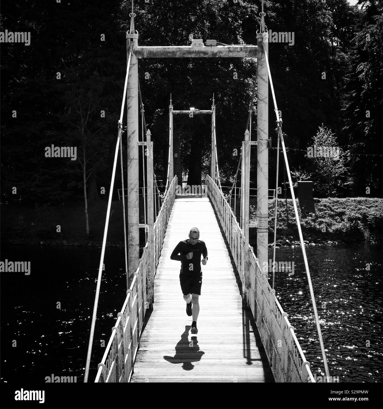 Runner crossing the River Ness, Inverness, Scotland. - Smartphone Captured Stock Image