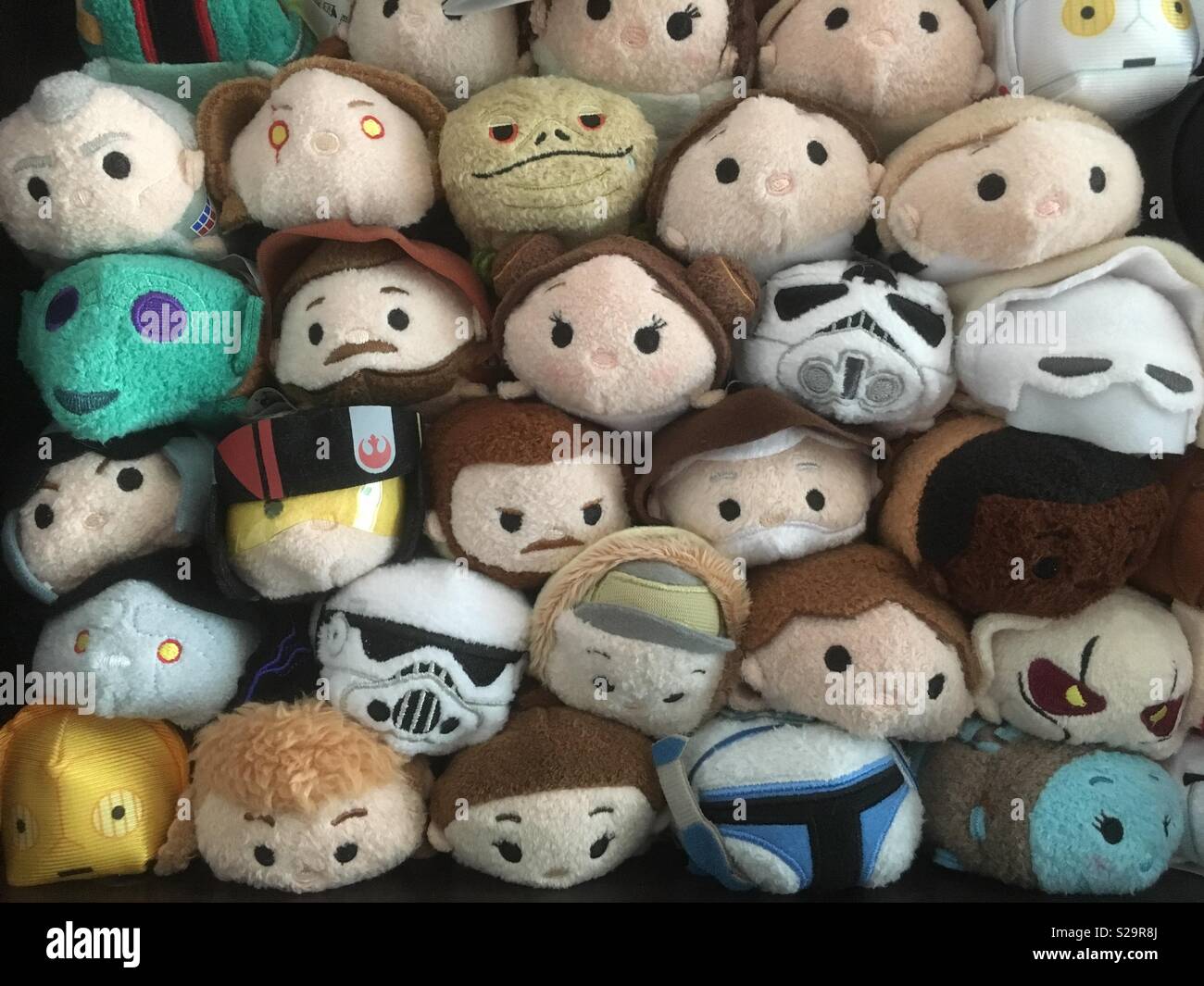Pile of cartoon toys faces in a group Stock Photo