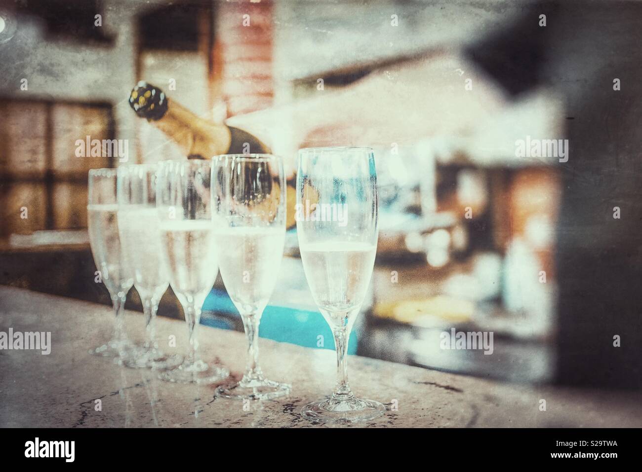 Bartender pouting sparkling white wine on glasses - Smartphone Captured Stock Image