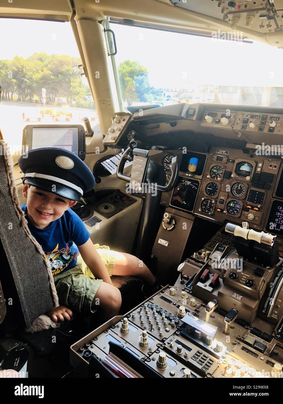 Kid in cockpit with pilots hat Stock Photo - Alamy