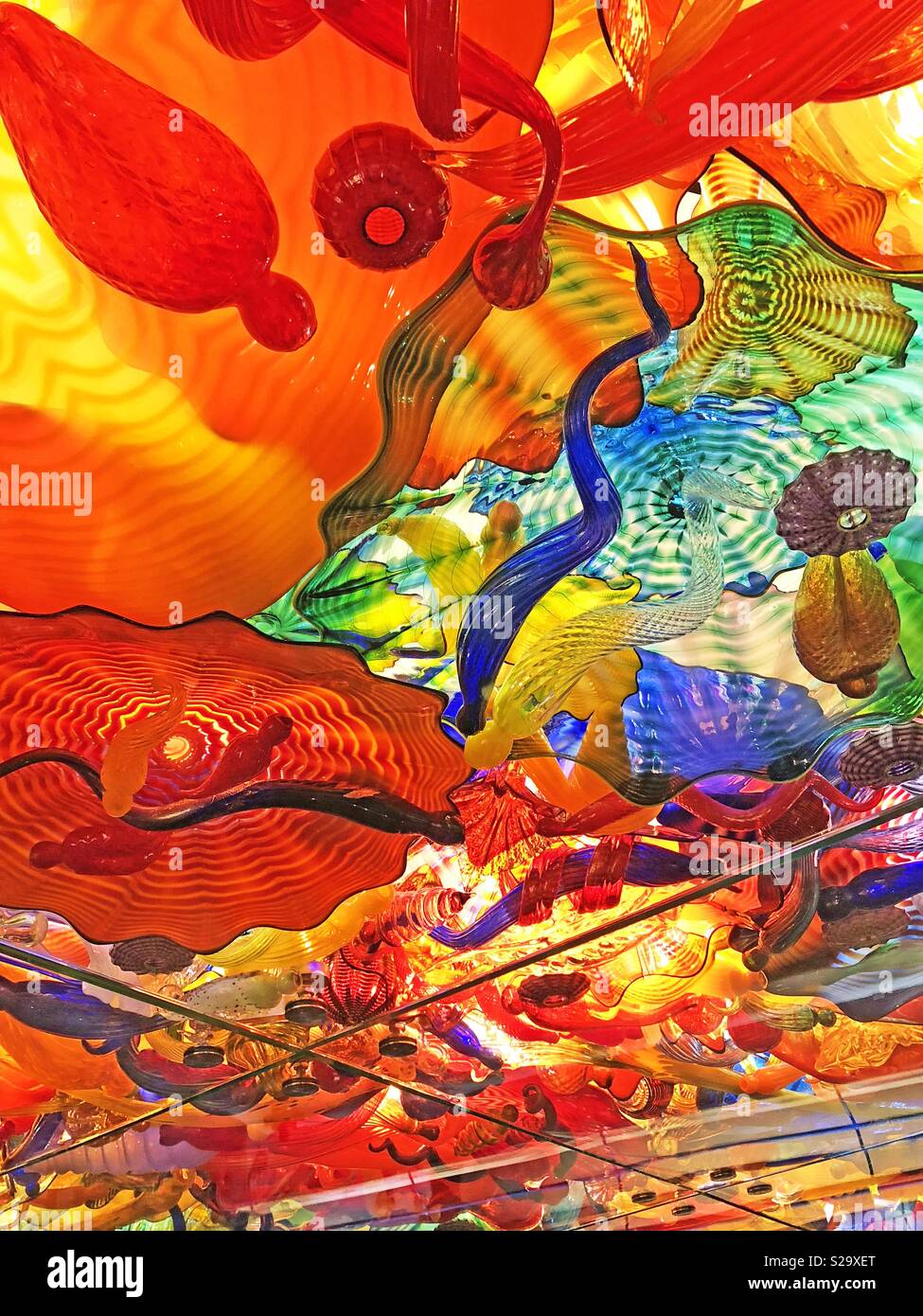 Bright colorful abstract glass art background texture in reds, blues, greens and yellows. - Smartphone Captured Stock Image