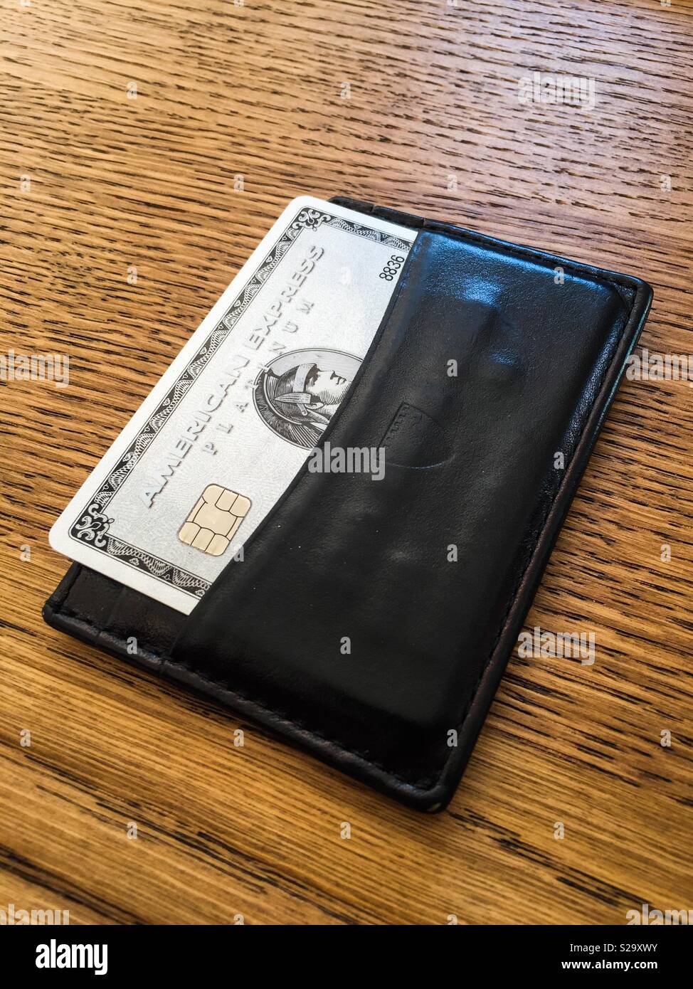 Platinum American Express charge card in a leather card holder. Stock Photo