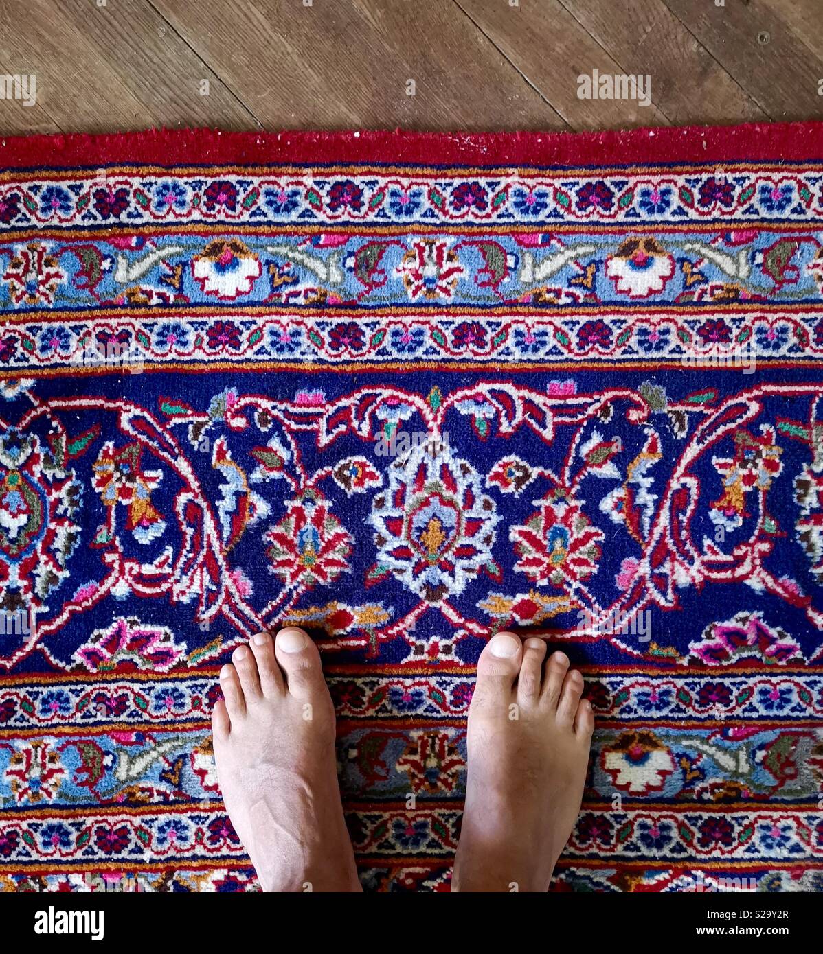 Barefoot male feet on Persian rug Stock Photo Alamy