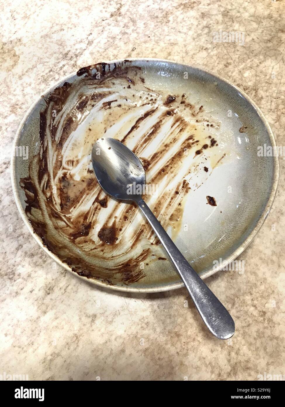 Dessert bowl with eaten chocolate brownie Stock Photo