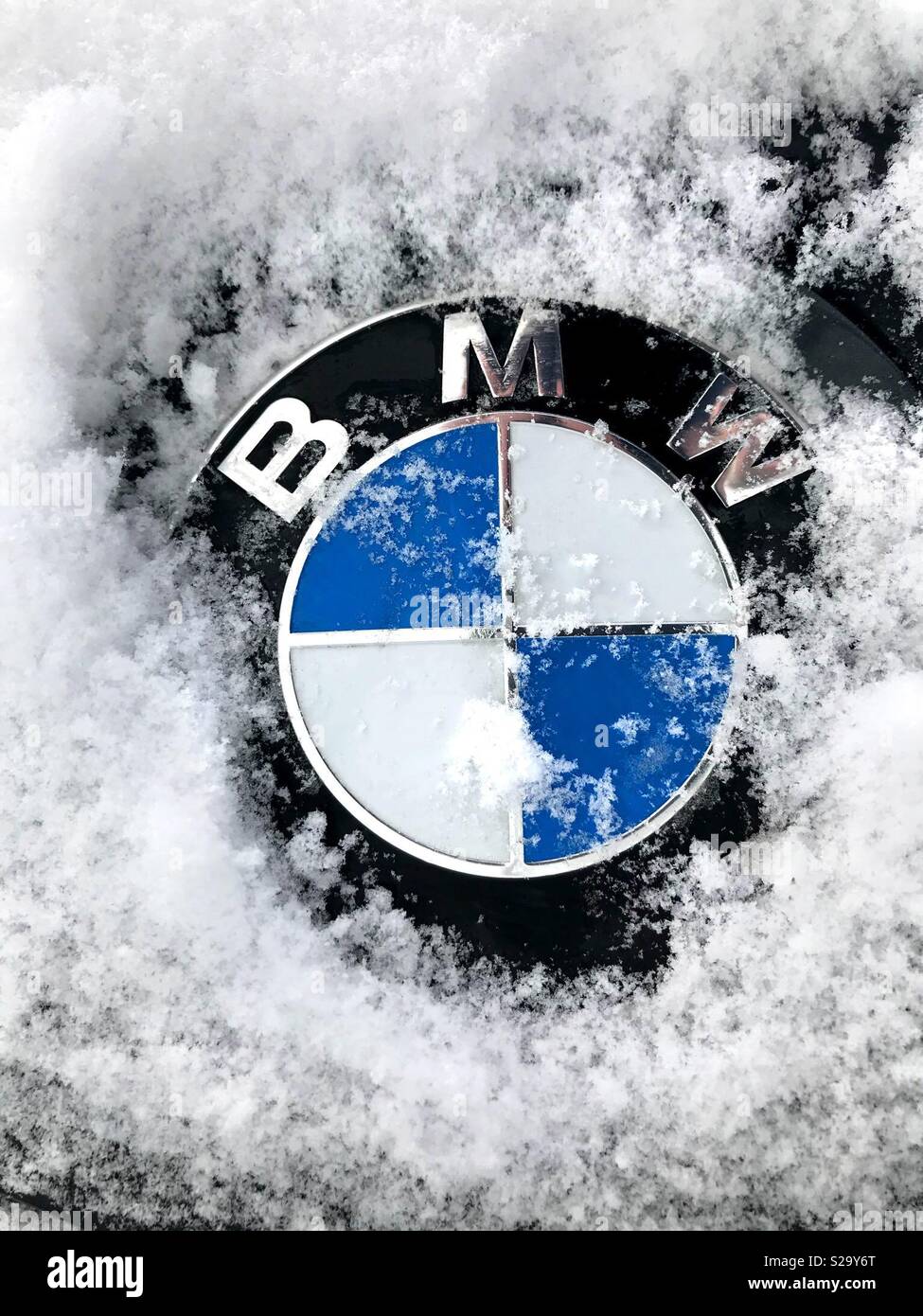 BMW badge covered in snow Stock Photo - Alamy