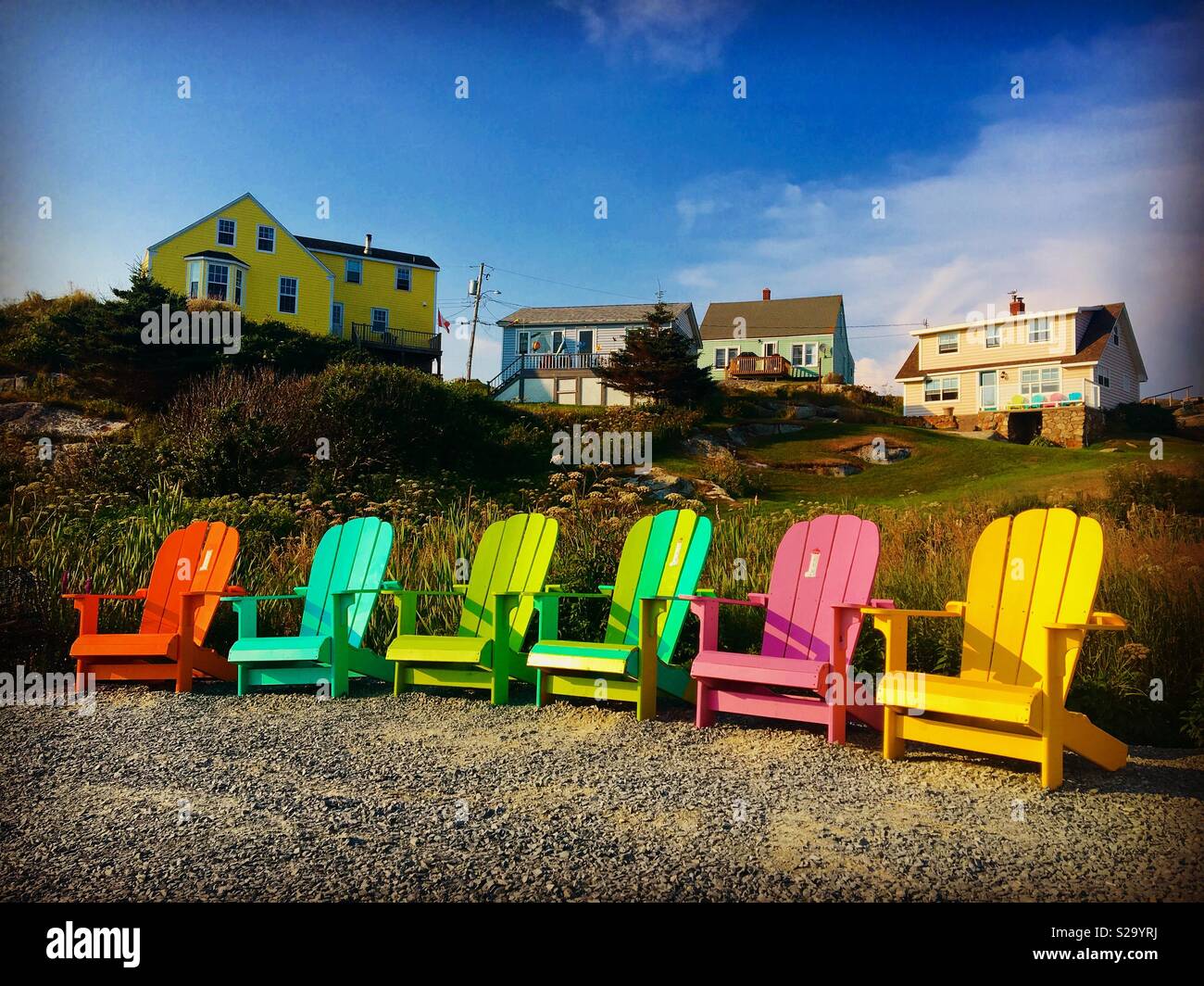 Colourful Adirondack chairs in Peggy’s Cove Nova Scotia Canada Stock