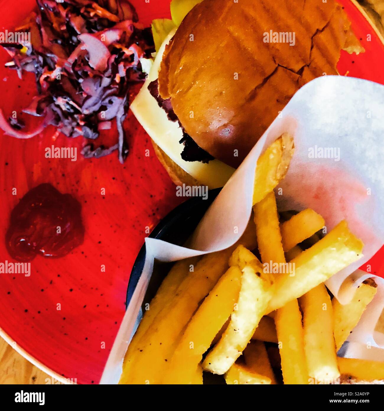 Deli style burger with red slaw and chips Stock Photo