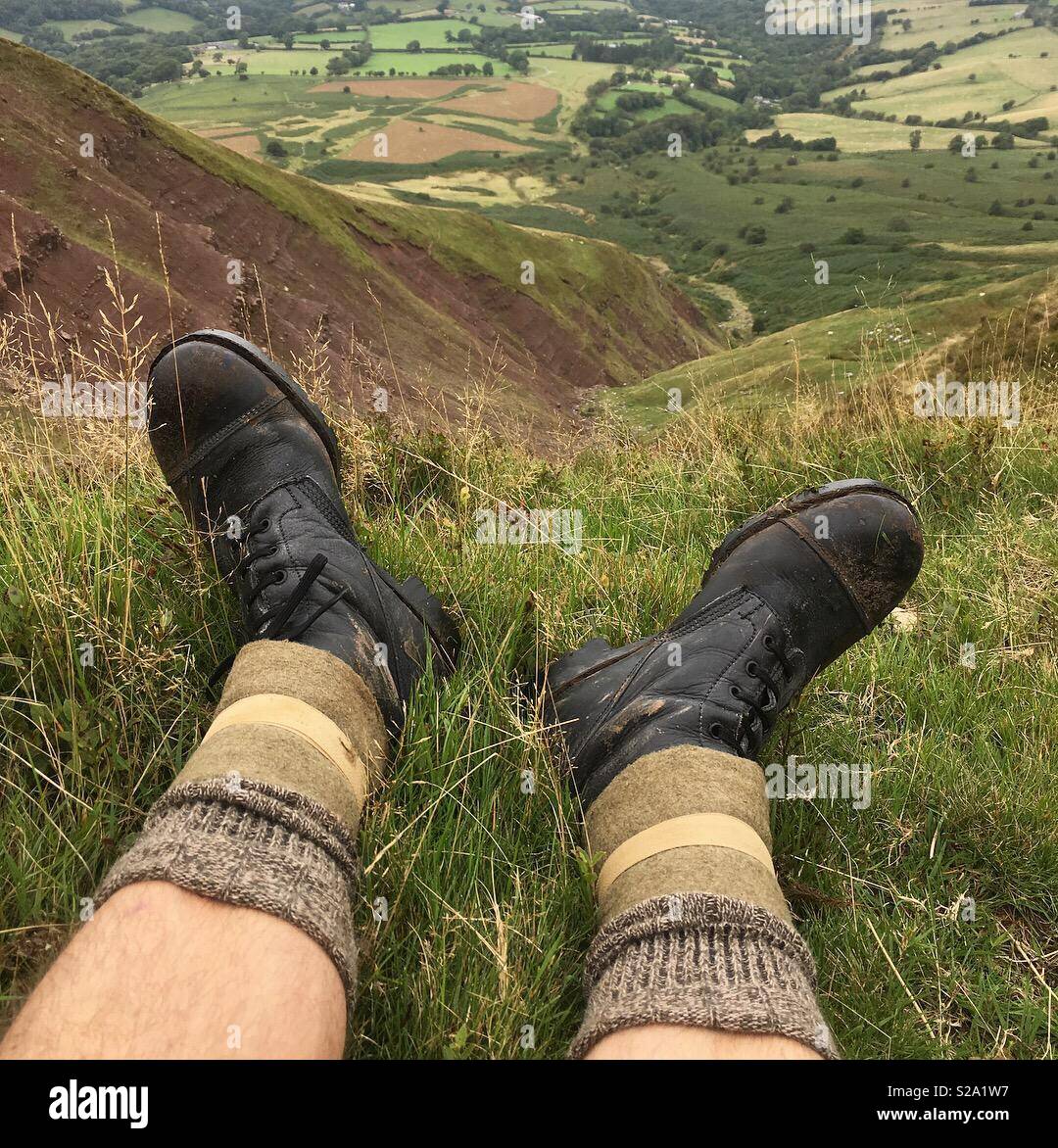 Hiking up ‘Lord Hereford’s Knob’, (Twmpa 690m) in the Black Mountains of the Brecon Beacons. Taking a break as we climbed the steep slope to the top of the ridge. Stock Photo