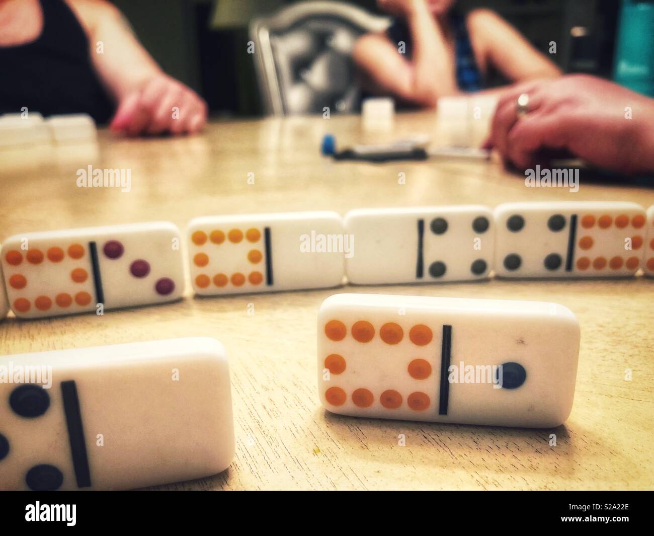 Three people playing dominos - Smartphone Captured Stock Image