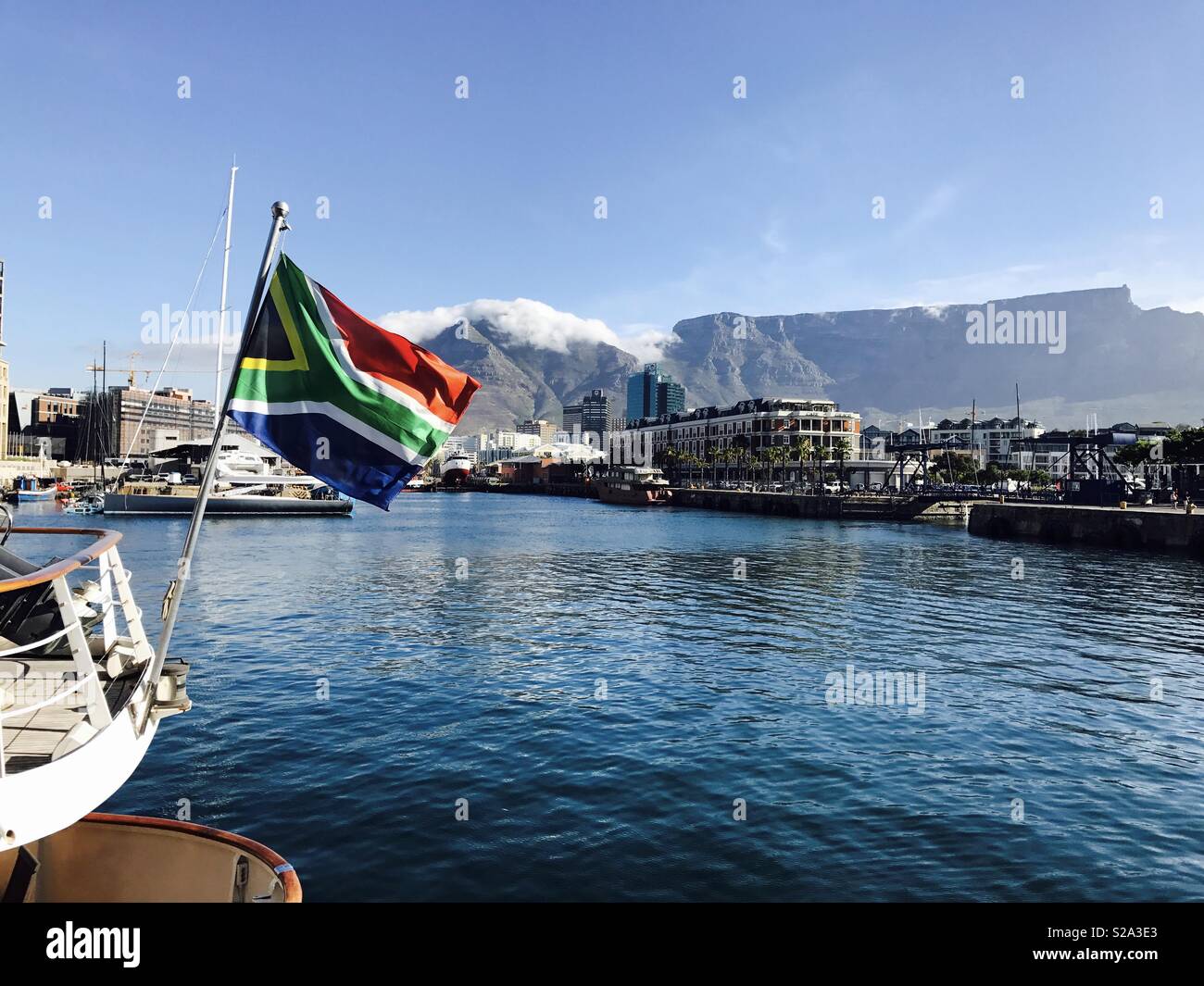 South African flag flying from boat in front of Table Mountain, Cape Town. Stock Photo