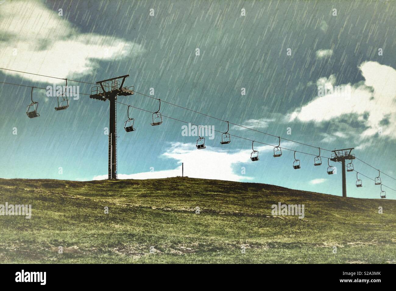 Chair lift at ski resort during rainy day - Smartphone Captured Stock Image