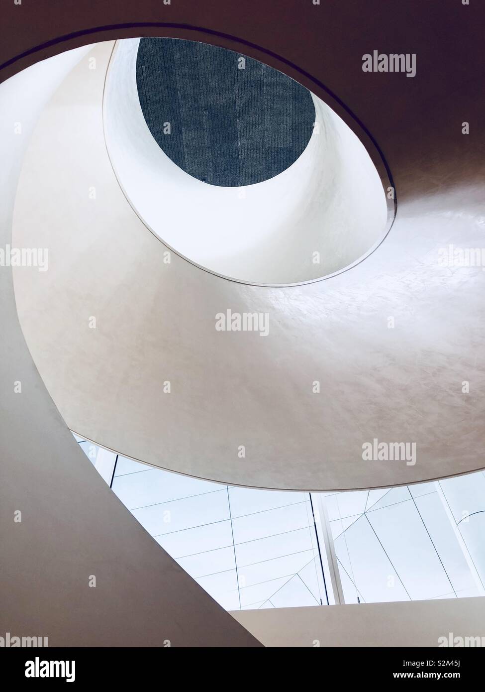 Beautifully designed inside spiraling staircase looking up in the early morning light at the Seamarq Hotel in Gangneung, South Korea . Designed by architect Richard Meier - Smartphone Captured Stock Image