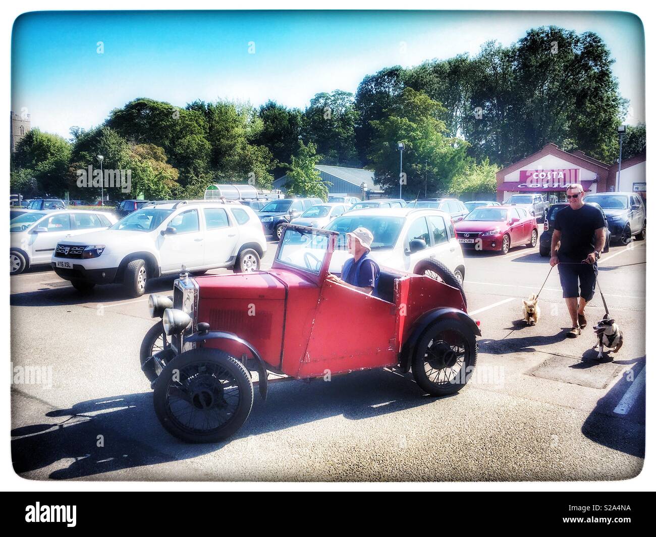 Vintage car pulling out of a supermarket carpark - Smartphone Captured Stock Image
