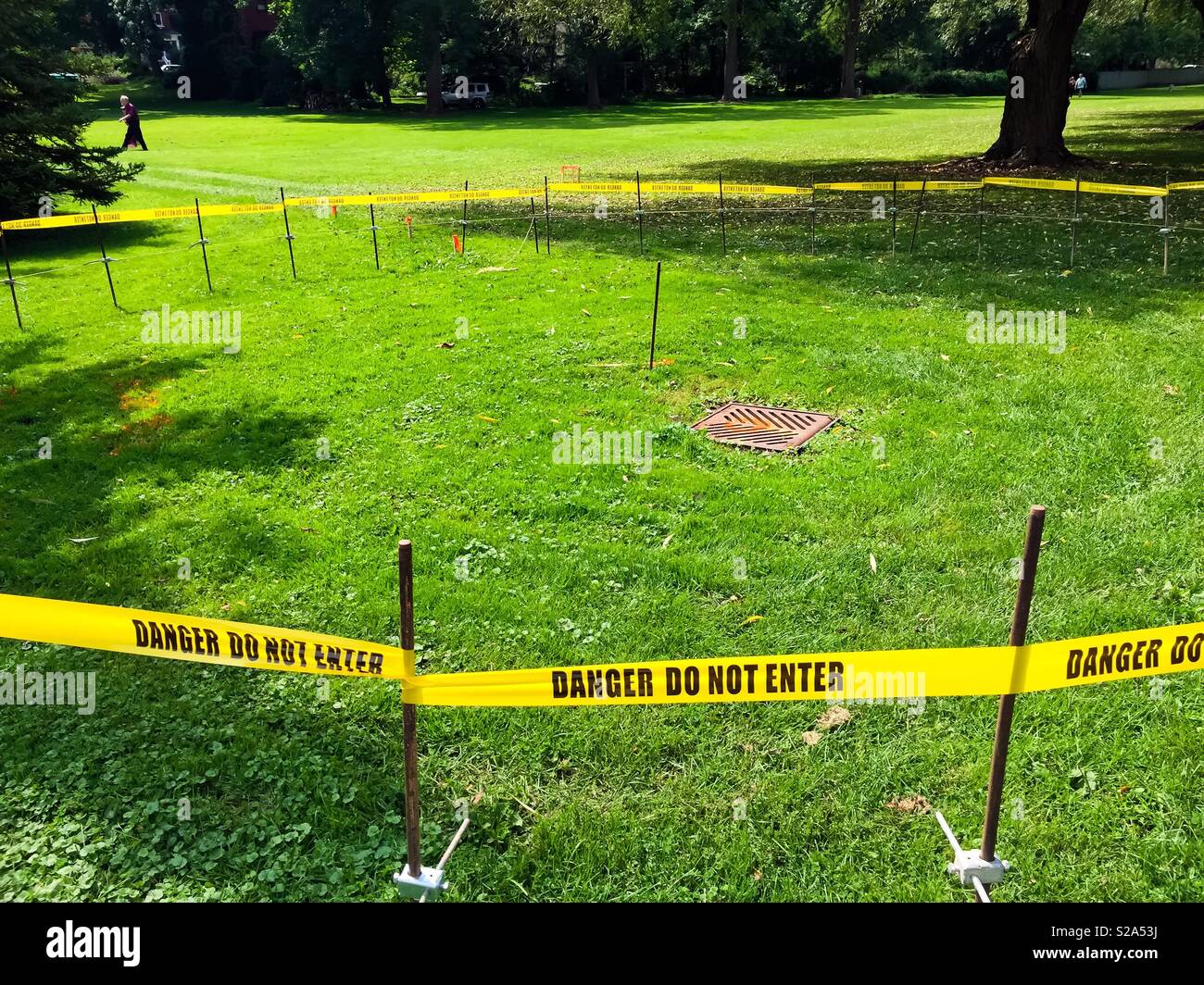 Unspecified Danger, Do Not Enter yellow tape, in a lovely park, Ontario, Canada - Smartphone Captured Stock Image