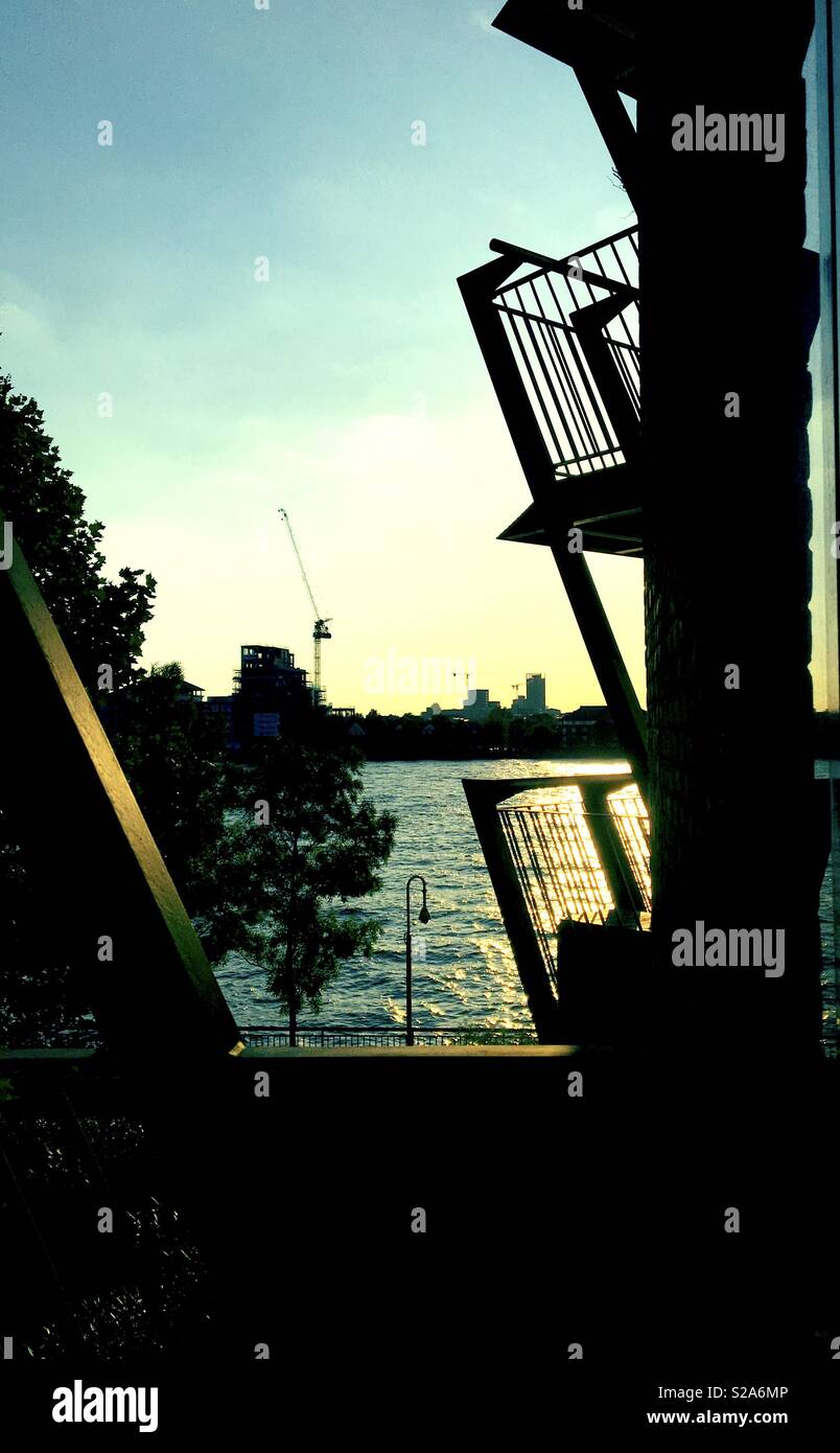 London apartment balcony view of the river Thames and view of city with ...