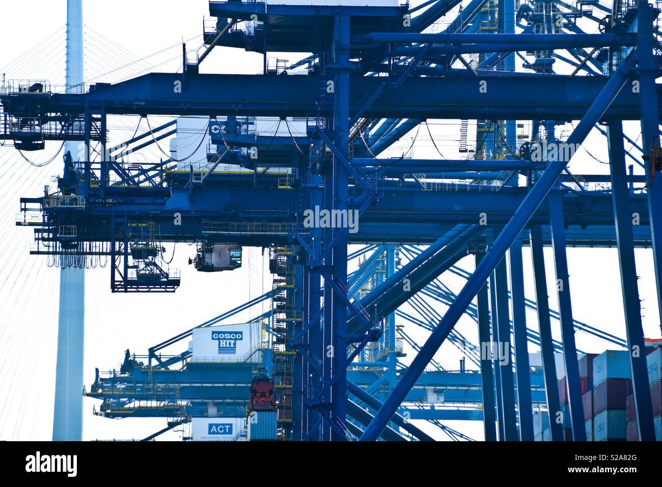 Blue cranes in industrial port Hong Kong Stock Photo