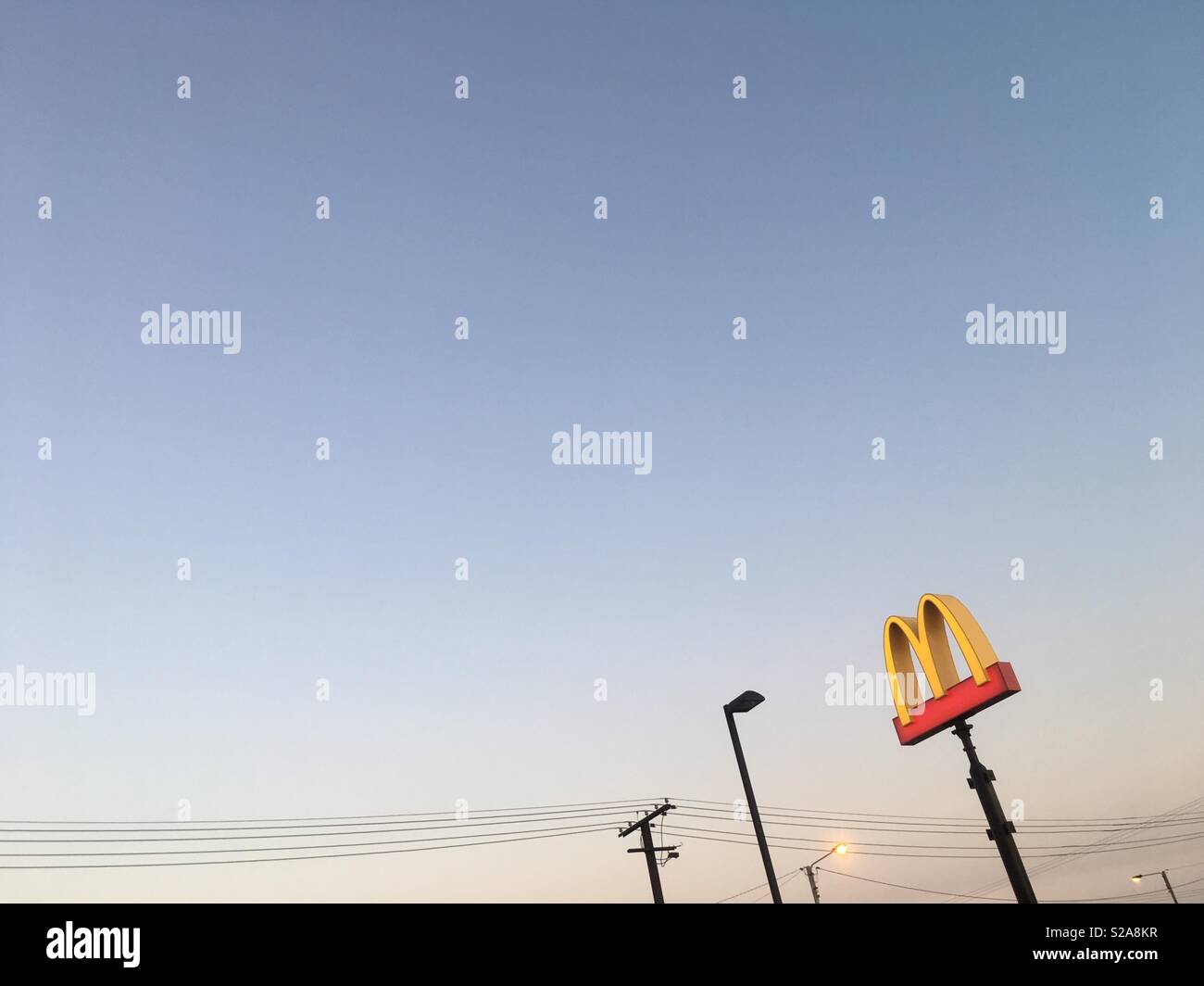 The MacDonald’s golden arch against the sky at dusk. - Smartphone Captured Stock Image