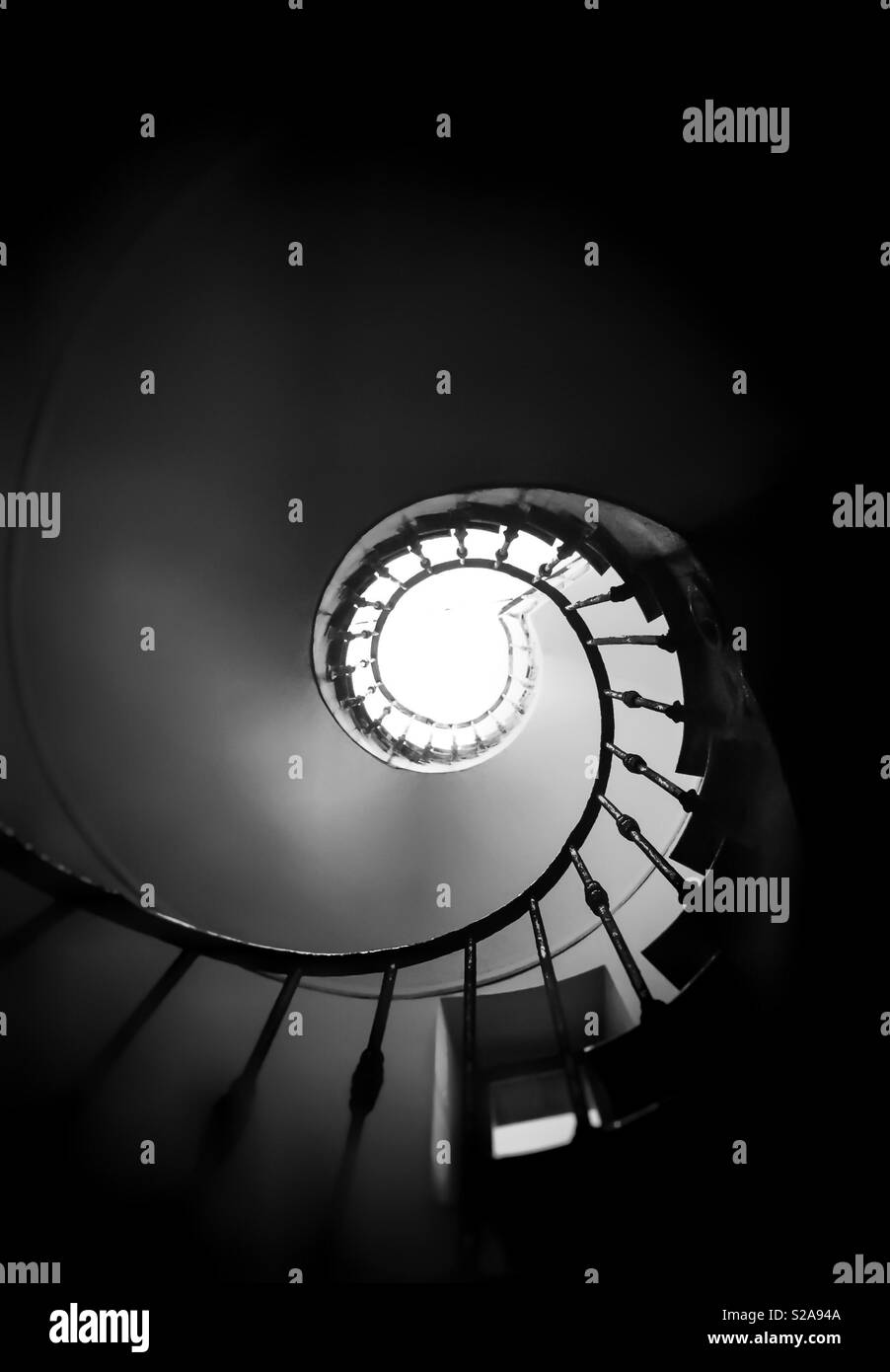 Ancient spiral staircase seen from below. Black and white shot - Smartphone Captured Stock Image