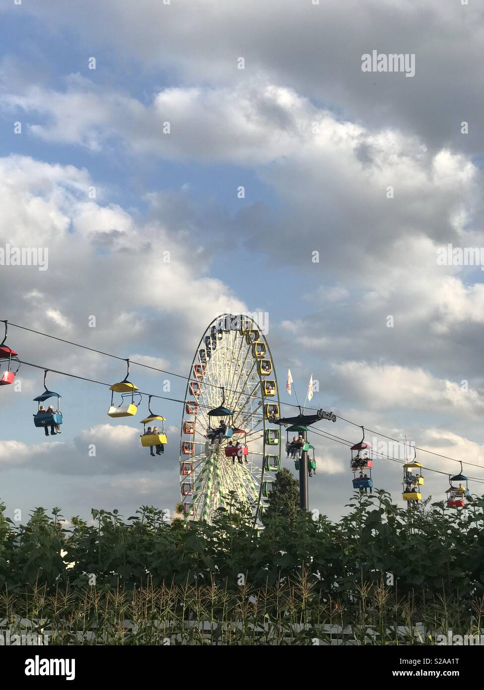 Ferris wheel and sky rider over corn at the state fair. Stock Photo