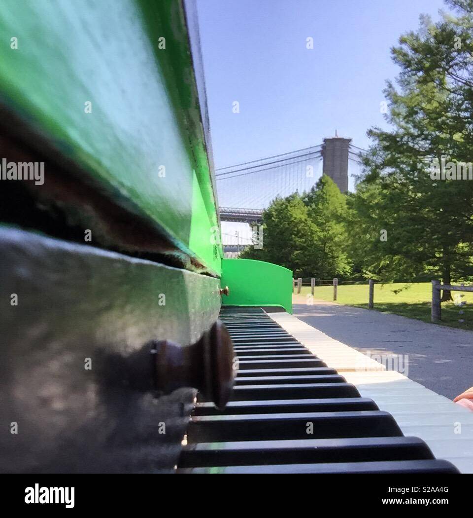 A piano in Brooklyn Bridge Park in the spring of 2018. Every summer the organization Sing For Hope places pianos around the city. Stock Photo