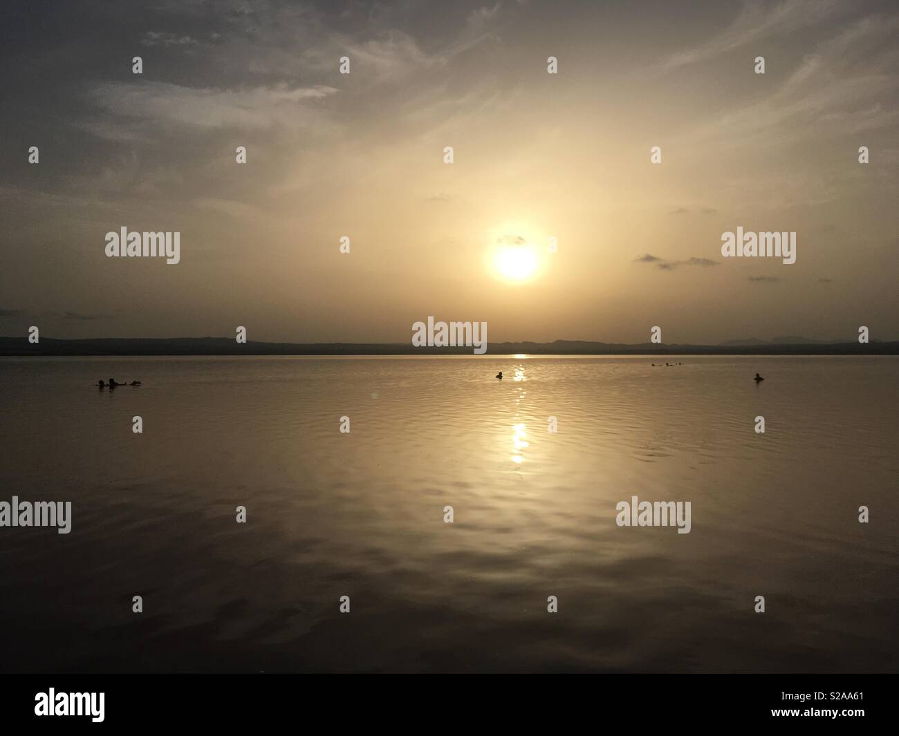 Glowing sun reflected in the waters of Salt lake Las Salinas in Torrevieja at sunset. Costa Blanca. Spain Stock Photo
