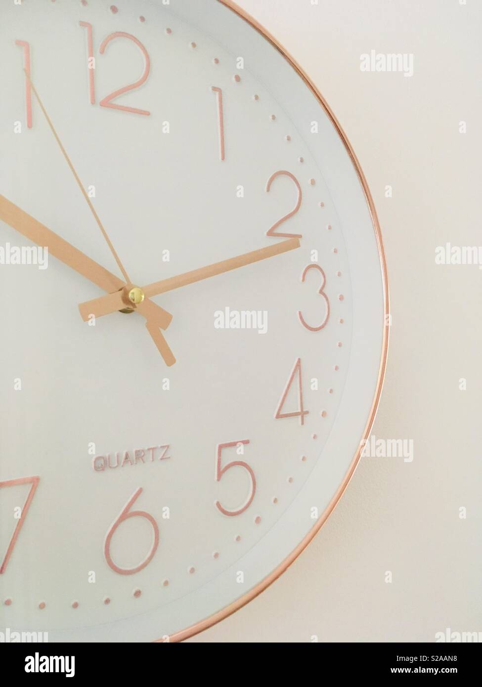 White and copper clock telling the time Stock Photo