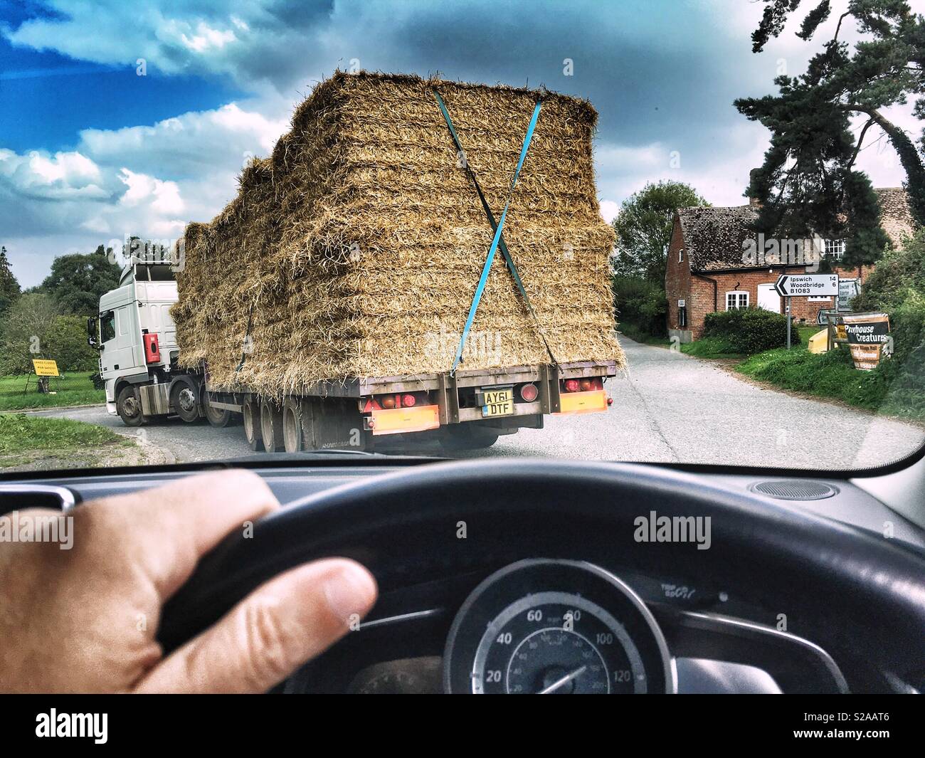 Driving behind a lorry loaded with straw bales, Shottisham, Suffolk, UK. - Smartphone Captured Stock Image