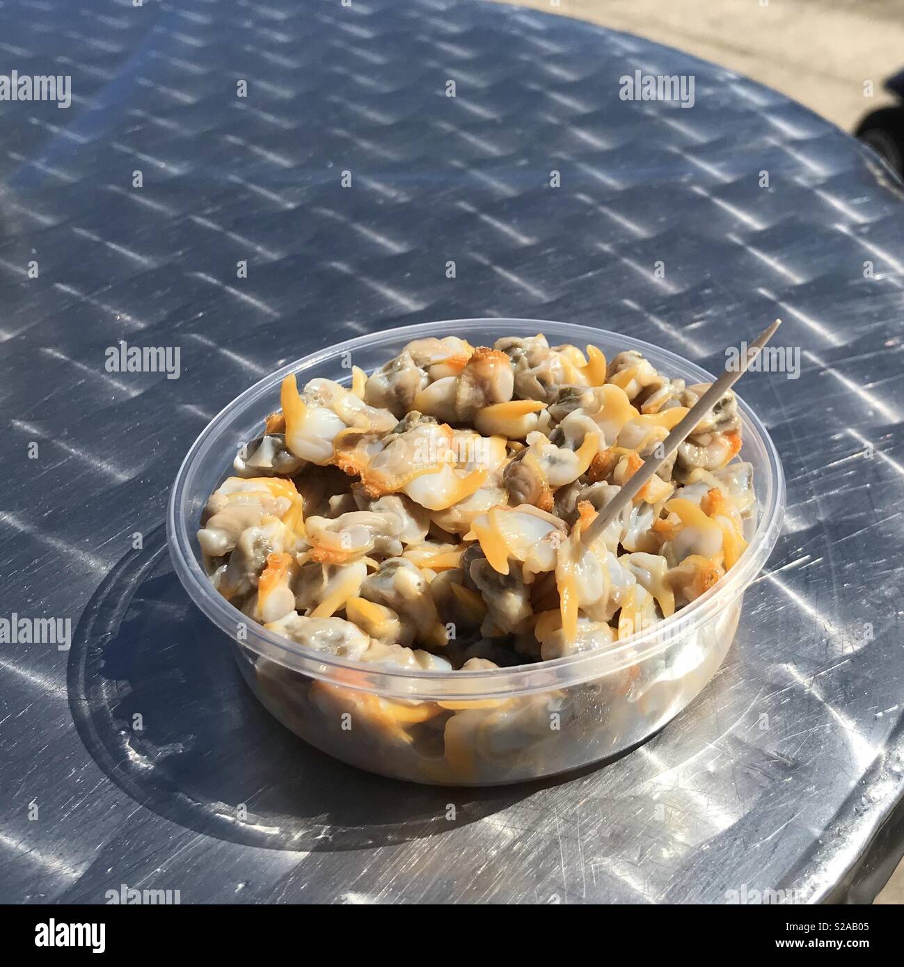Tub of traditional British seaside cockles in vinegar and pepper Stock