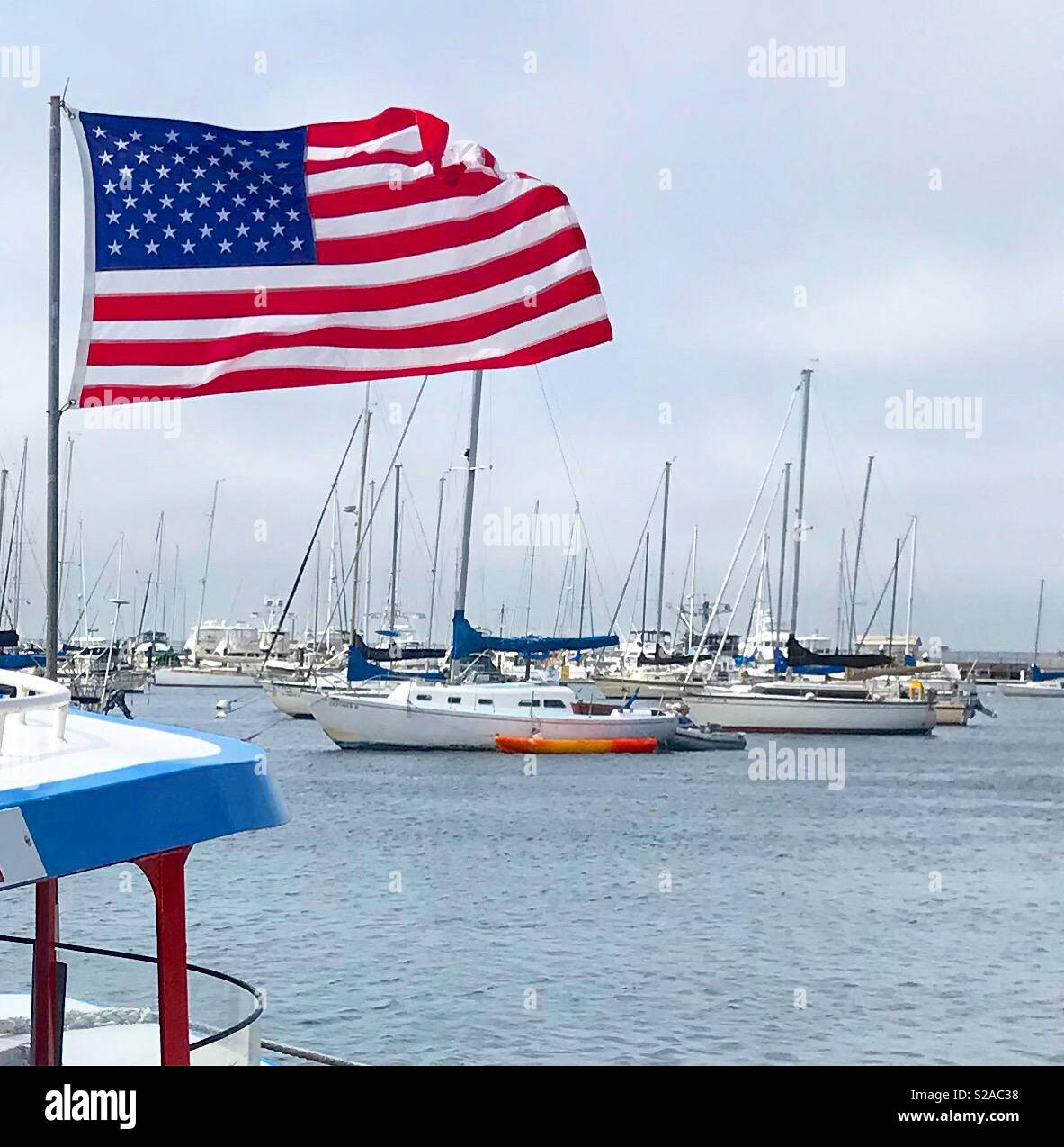 American flag flying on the side of a boat in Monterey Bay Stock Photo